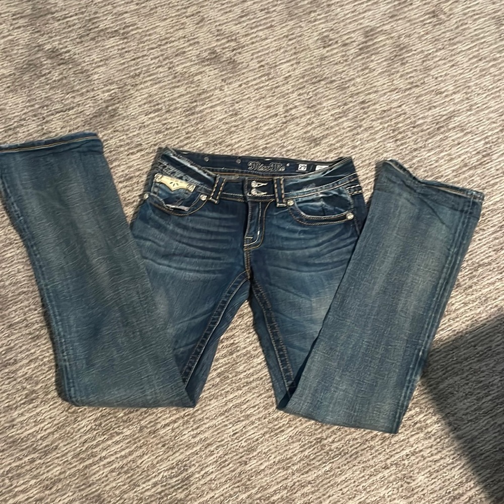 Women’s Miss Me jeans, boot cut with leather flap pockets.